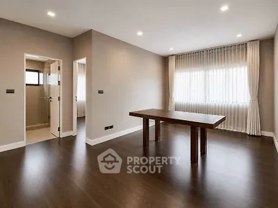 Spacious modern living room with elegant wooden flooring and natural light.