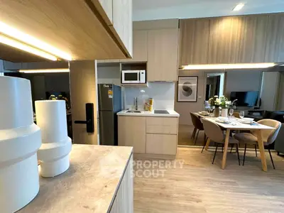 Modern kitchen and dining area with sleek design and wooden accents