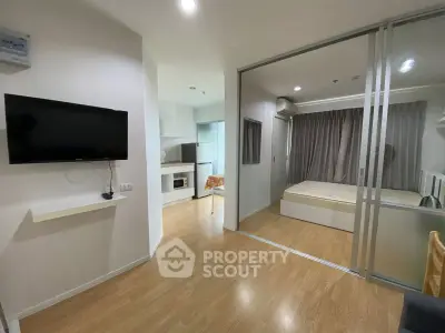 Modern studio apartment with open layout, featuring a cozy bedroom and sleek kitchen area.