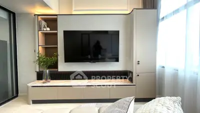 Modern living room with sleek TV unit and natural light