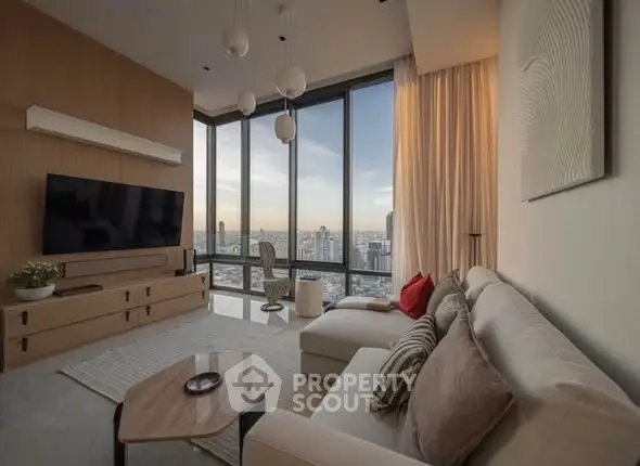 Luxurious living room with panoramic city view, modern decor, and cozy seating area.