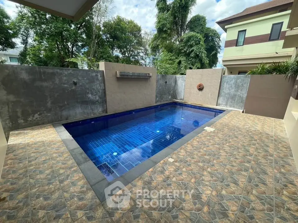 Luxurious private pool with elegant tile design in a serene residential setting.