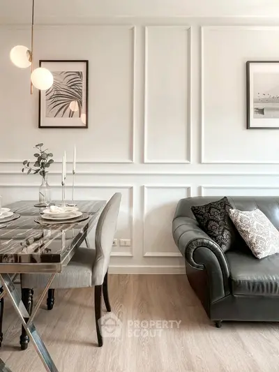 Elegant living room with chic dining area, featuring modern decor and stylish lighting.