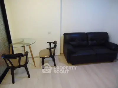 Modern living room with sleek black sofa and stylish glass table