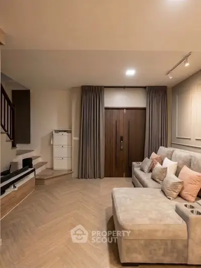 Spacious modern living room with elegant decor and cozy seating area, perfect for relaxation and entertainment.