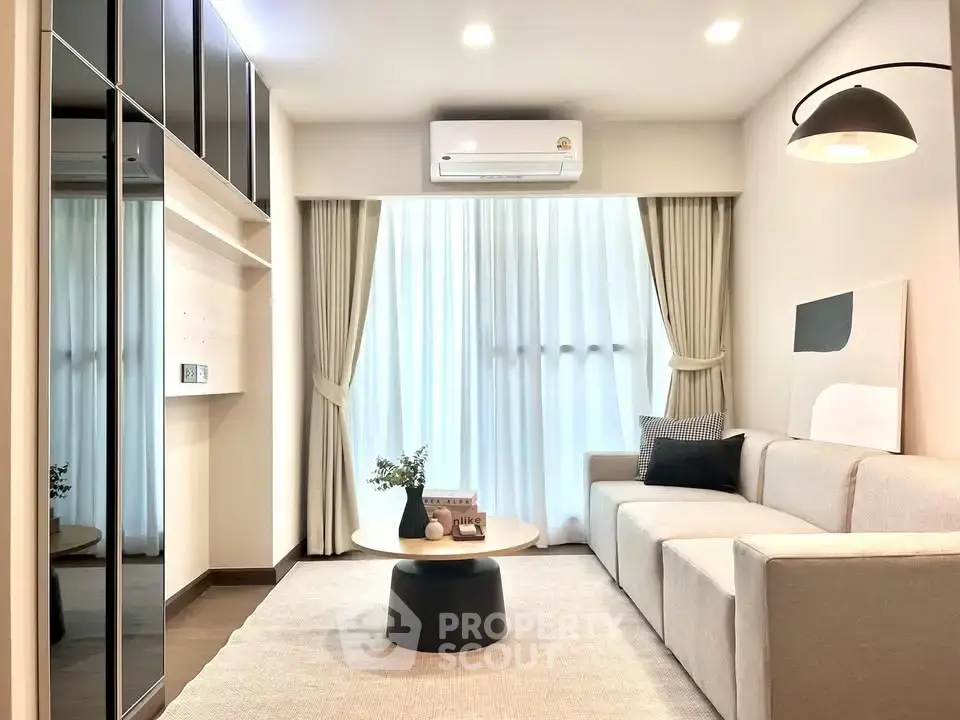 Modern living room with sleek design, featuring a comfortable sofa, stylish decor, and ample natural light.