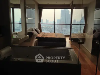 Luxurious bedroom with stunning city view and modern bathtub in high-rise apartment.