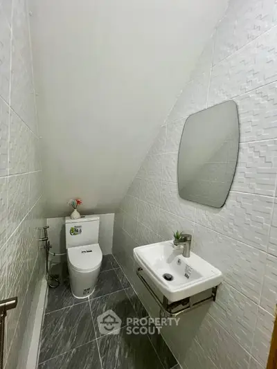 Compact modern bathroom with sleek design and efficient use of space.