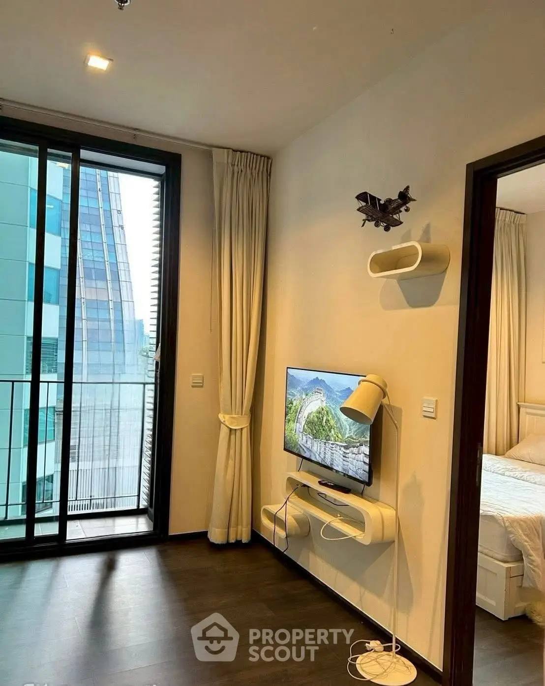 Modern apartment with sleek interior design and city view from balcony.