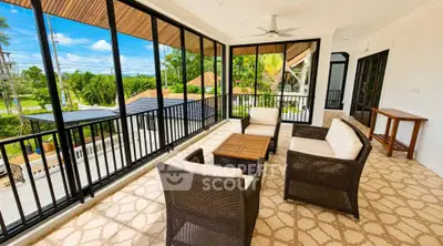Spacious balcony with comfortable seating and scenic view in modern home