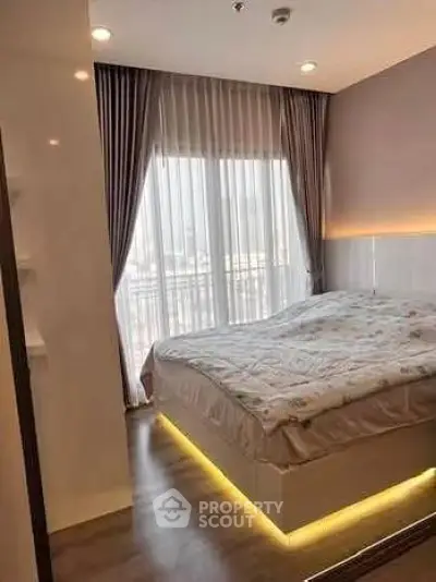 Modern bedroom with stylish lighting and floor-to-ceiling windows