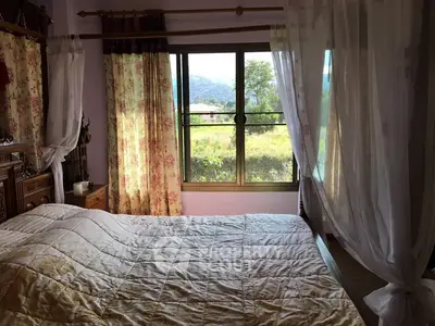 Cozy bedroom with floral curtains and scenic window view