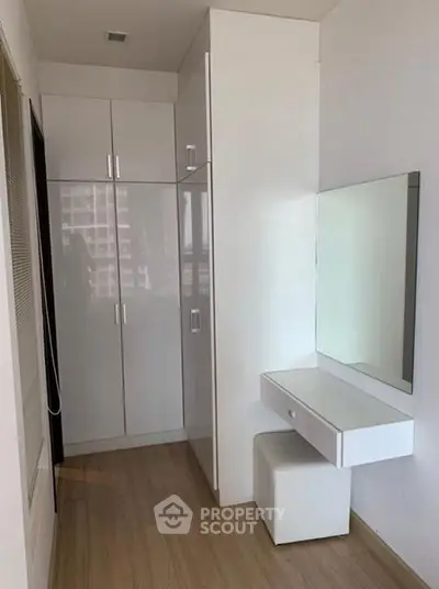 Modern bedroom with sleek white wardrobe and vanity set