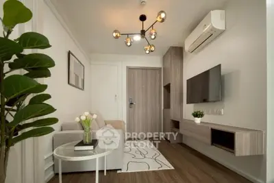 Modern living room with stylish decor and wall-mounted TV in a cozy apartment.