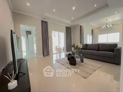 Spacious modern living room with elegant decor and ample natural light.