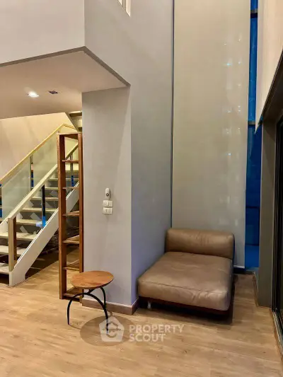 Modern interior with high ceilings and stylish staircase in a contemporary living space.