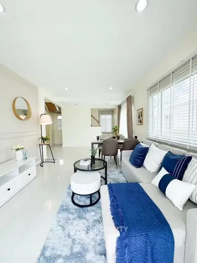 Spacious and stylish living room with modern decor and ample natural light.