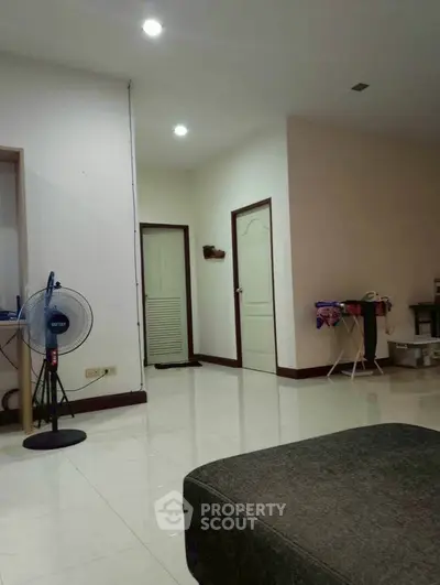 Spacious living room with modern decor and ample natural light