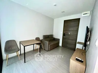 Modern minimalist living room with compact furniture and neutral tones