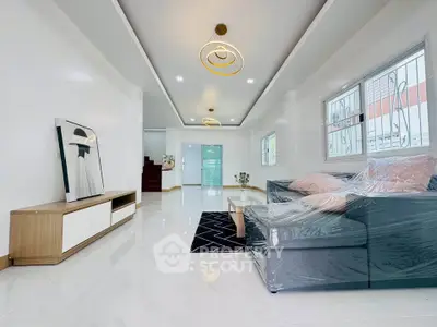 Spacious modern living room with stylish decor and ample natural light