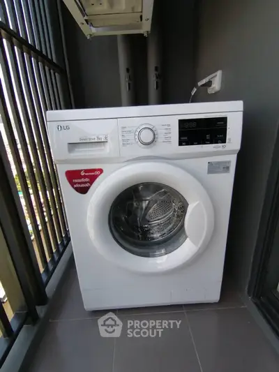 Modern washing machine on a balcony with city view, perfect for urban living convenience.