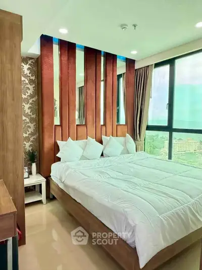 Luxurious bedroom with modern decor and large windows offering stunning city views.