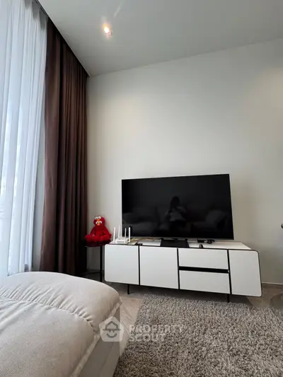 Modern living room with sleek TV setup and cozy decor