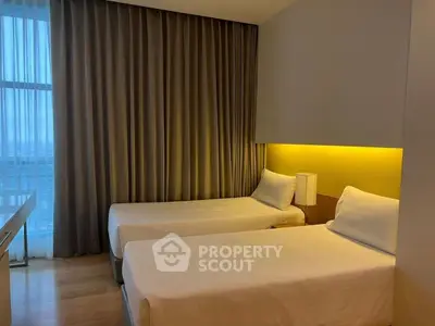 Modern bedroom with twin beds and floor-to-ceiling window in stylish apartment.