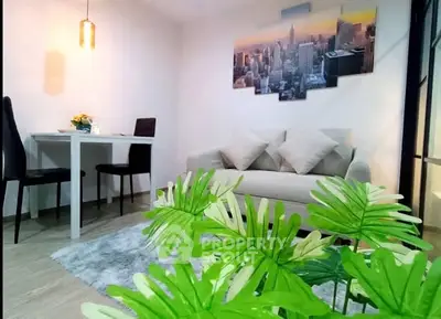 Chic modern living room with cozy sofa, stylish decor, and vibrant greenery for a welcoming ambiance.