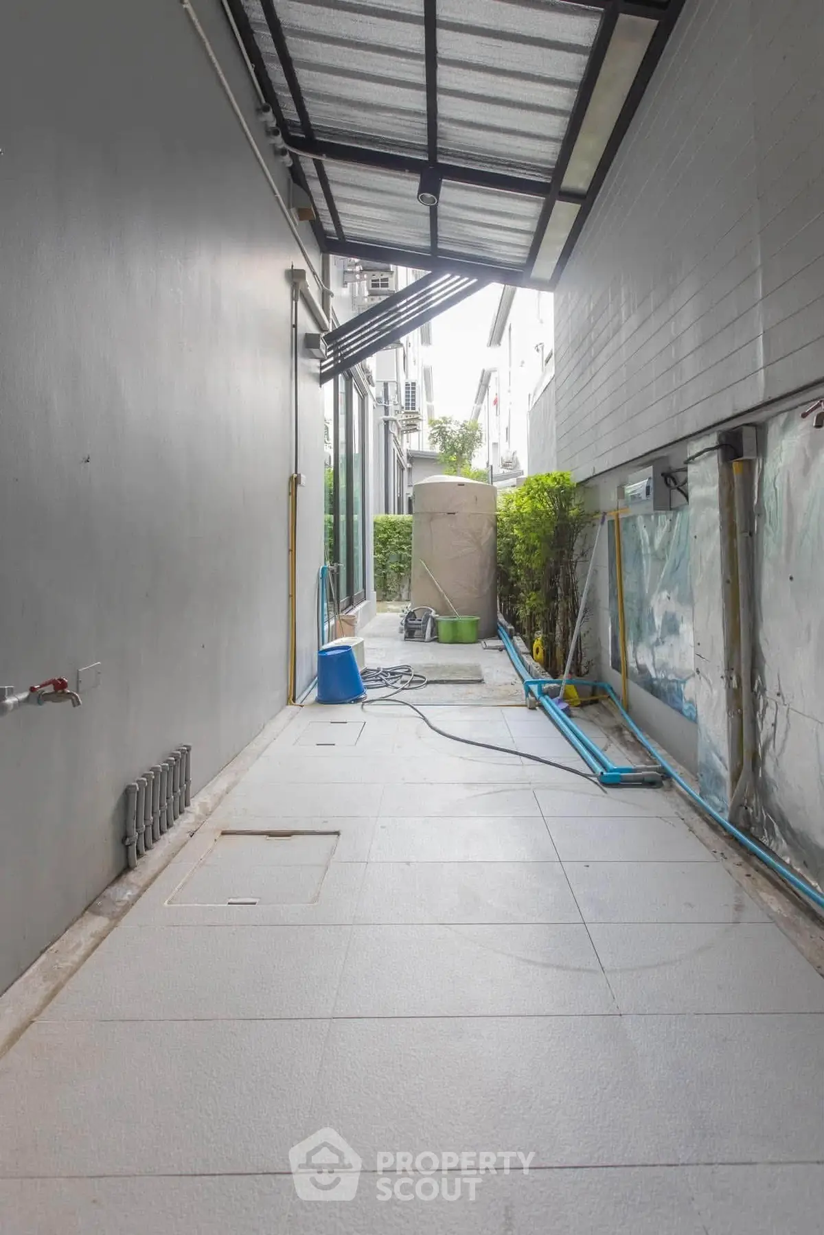 Spacious outdoor corridor with modern design and covered roof, ideal for utility or storage use.