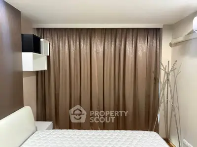 Cozy bedroom with modern decor and ample natural light