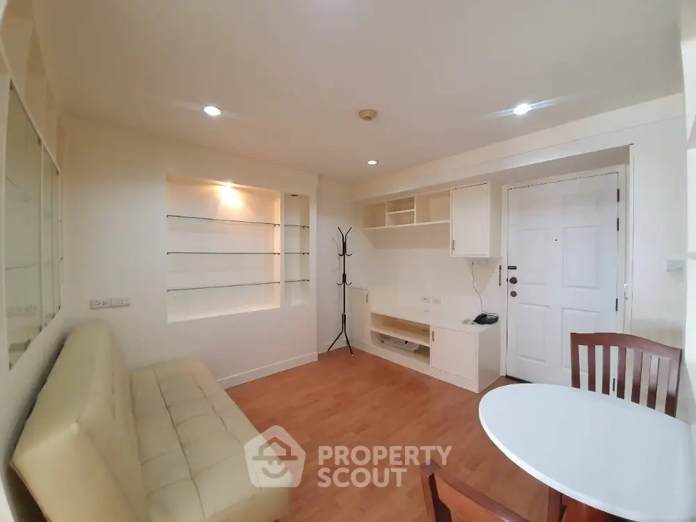 Spacious and bright studio apartment with an open layout combining a cozy living area, a modern kitchen, and ample storage space, perfect for urban living.