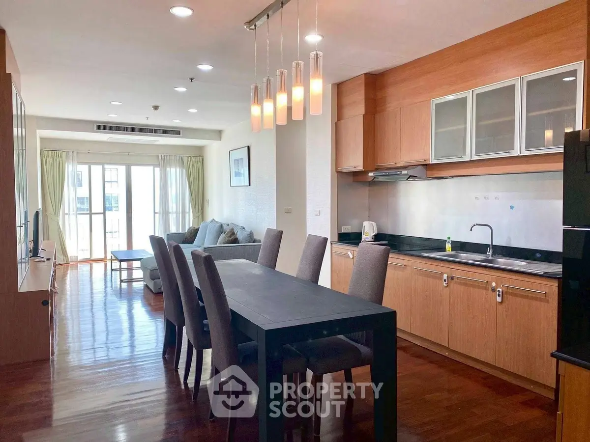Spacious open-layout kitchen and dining area with modern furnishings and natural light.