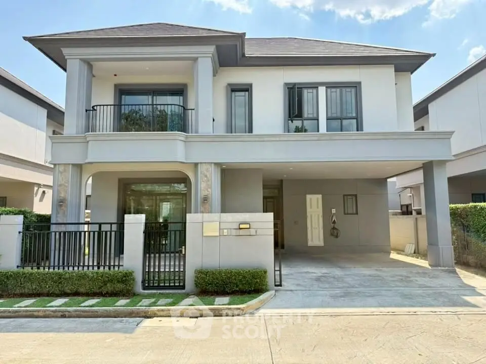 Elegant two-story modern house with spacious driveway and lush greenery, perfect for family living.
