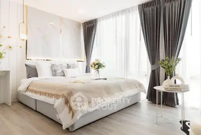 Luxurious bedroom with elegant decor and natural light, featuring stylish curtains and a cozy bed.