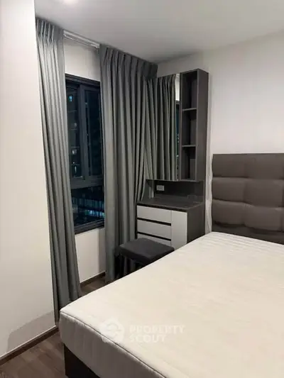 Modern bedroom with stylish decor and large window in urban apartment