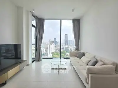 Spacious modern living room with stunning city view and elegant furnishings.
