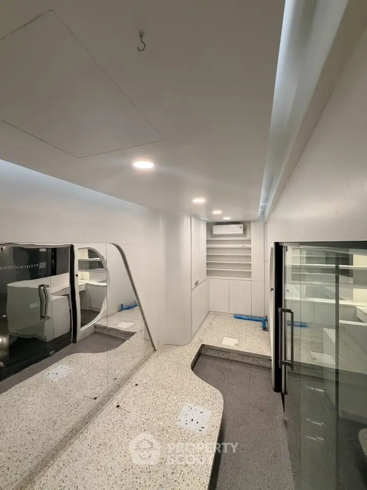 Modern minimalist interior with sleek design and built-in shelving, perfect for a contemporary lifestyle.