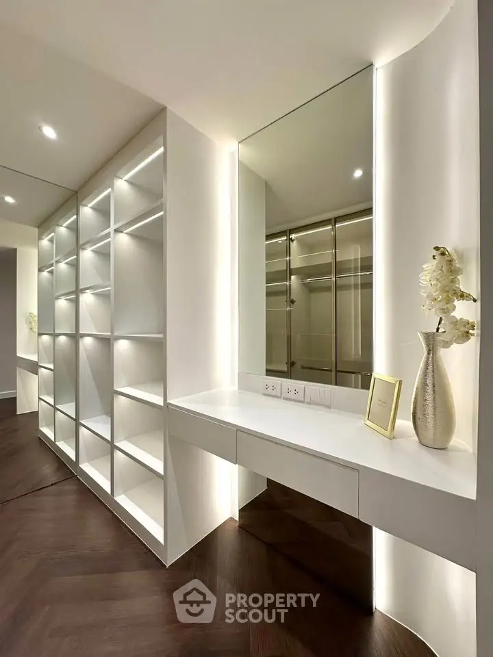 Luxurious walk-in closet with elegant shelving and modern lighting
