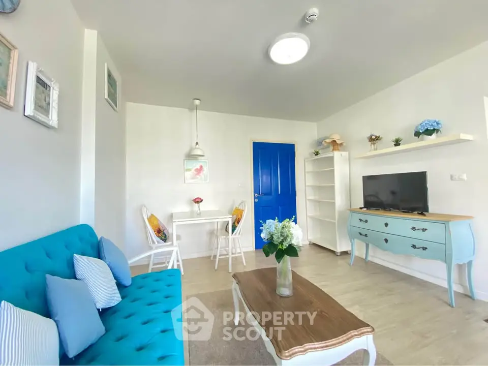 Charming living room with vibrant blue accents and cozy seating area