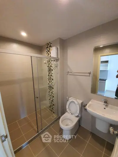 Modern bathroom with glass shower and sleek fixtures