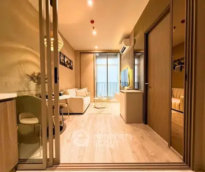 Modern living room with stylish decor and balcony view in a cozy apartment.