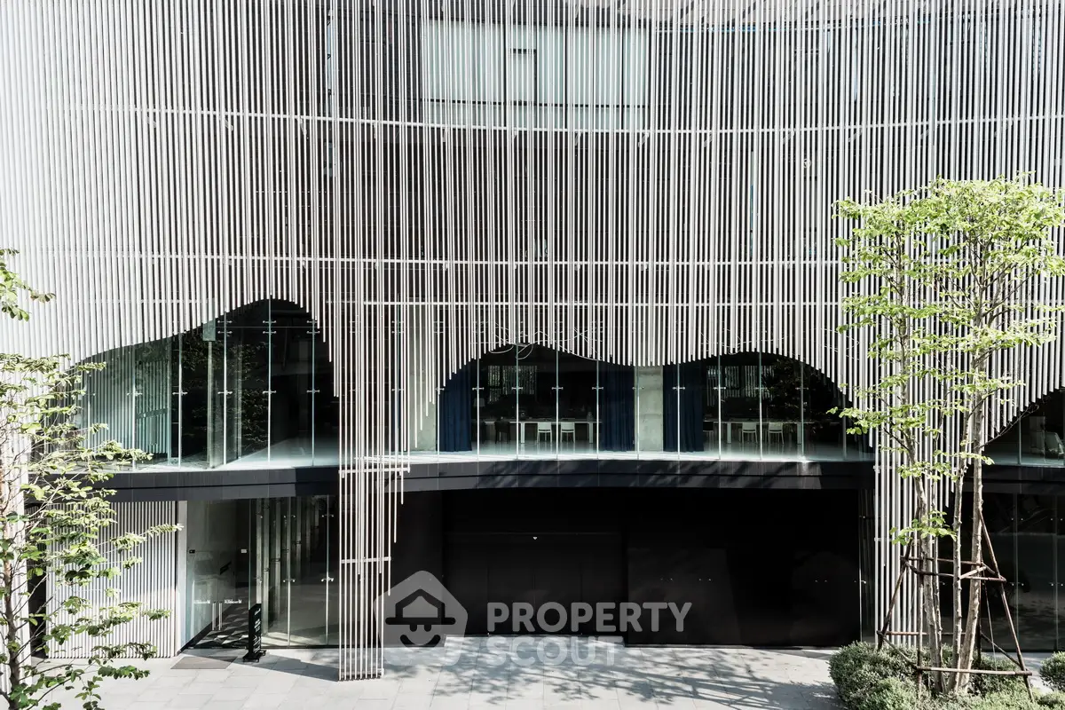 Modern architectural building facade with unique vertical slats and glass windows.