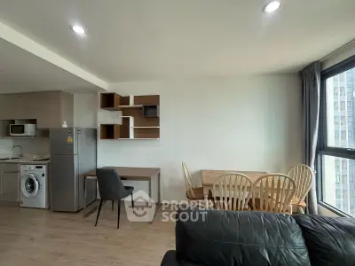 Modern apartment interior with open kitchen, dining area, and stylish shelving.