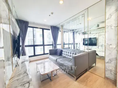 Luxurious modern living room with marble accents and large windows in a high-rise apartment.