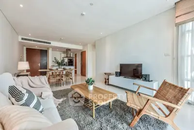 Spacious modern living room with cozy decor and open kitchen layout