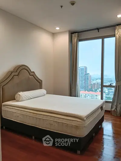 Spacious bedroom with city view and elegant decor
