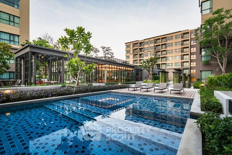 Luxurious condominium with modern pool and lush garden, perfect for relaxation and leisure.