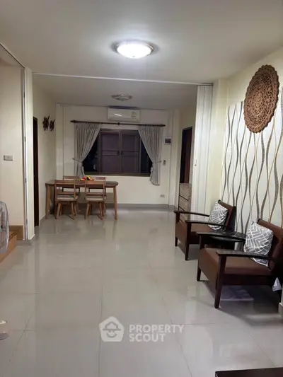 Spacious living room with modern decor and dining area, perfect for family gatherings.