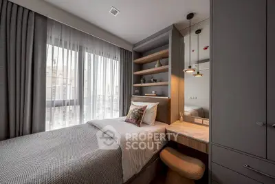 Modern bedroom with stylish decor and large window offering city views.